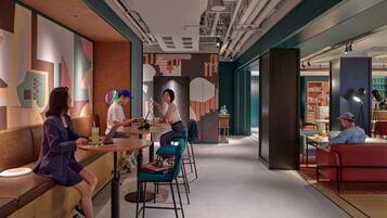 A modern interior with seating areas, tables, and a visible kitchen area.