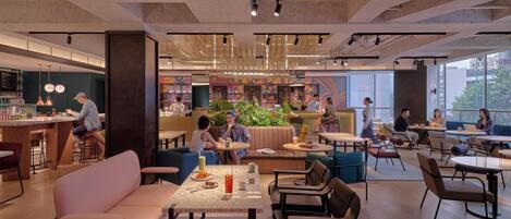 Een modern café met zitplaatsen, tafels en een bar.