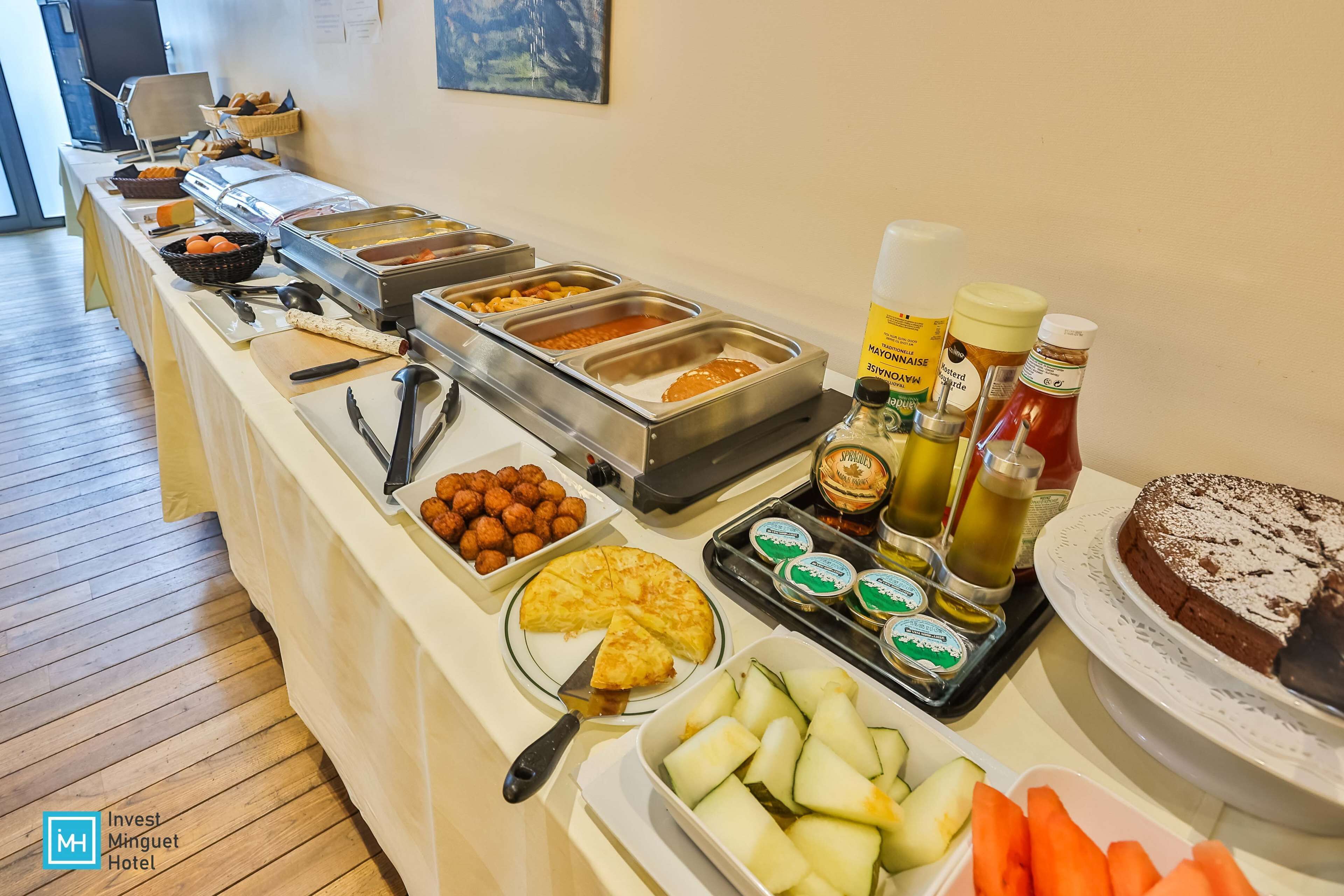 Un buffet con diversi cibi, salse e una torta.