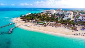 On the beach, white sand, sun-loungers, beach umbrellas