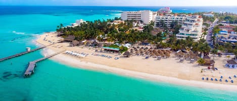 On the beach, white sand, sun loungers, beach umbrellas