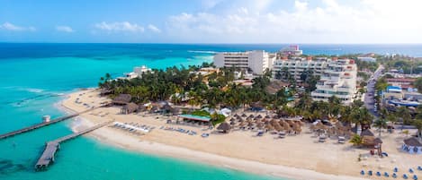 On the beach, white sand, sun loungers, beach umbrellas