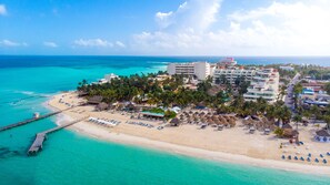 On the beach, white sand, sun loungers, beach umbrellas