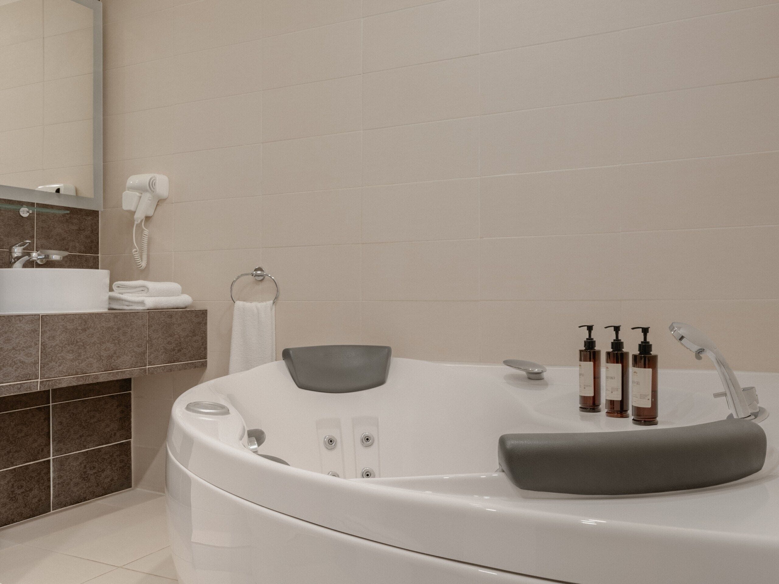 A modern bathroom with a freestanding bathtub, a vanity with a sink, and a mirror.