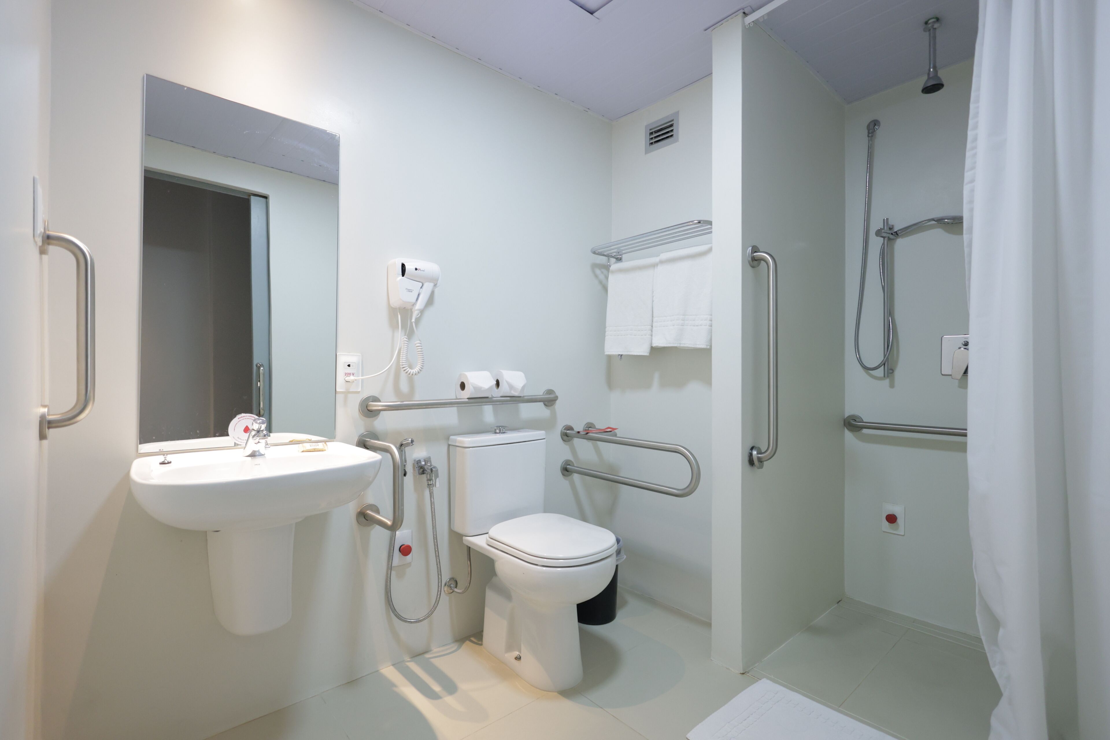 A modern bathroom with a sink, toilet, and shower.