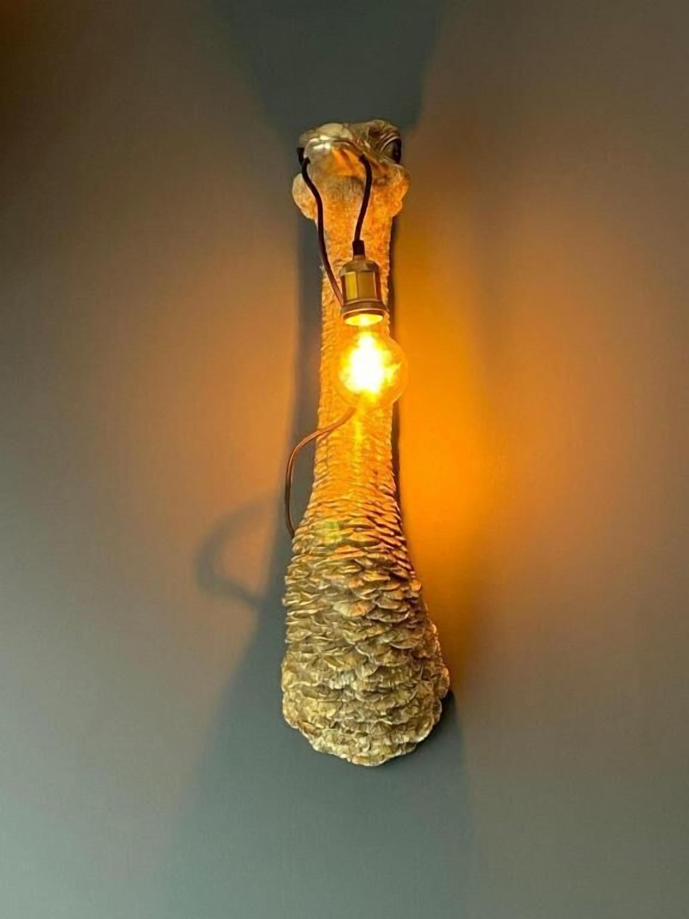 A decorative wall-mounted light fixture with a textured, metallic finish and a glowing bulb.