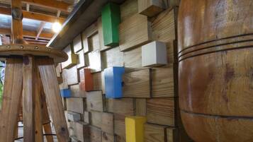 A wooden wall with colorful blocks and a large wooden barrel.
