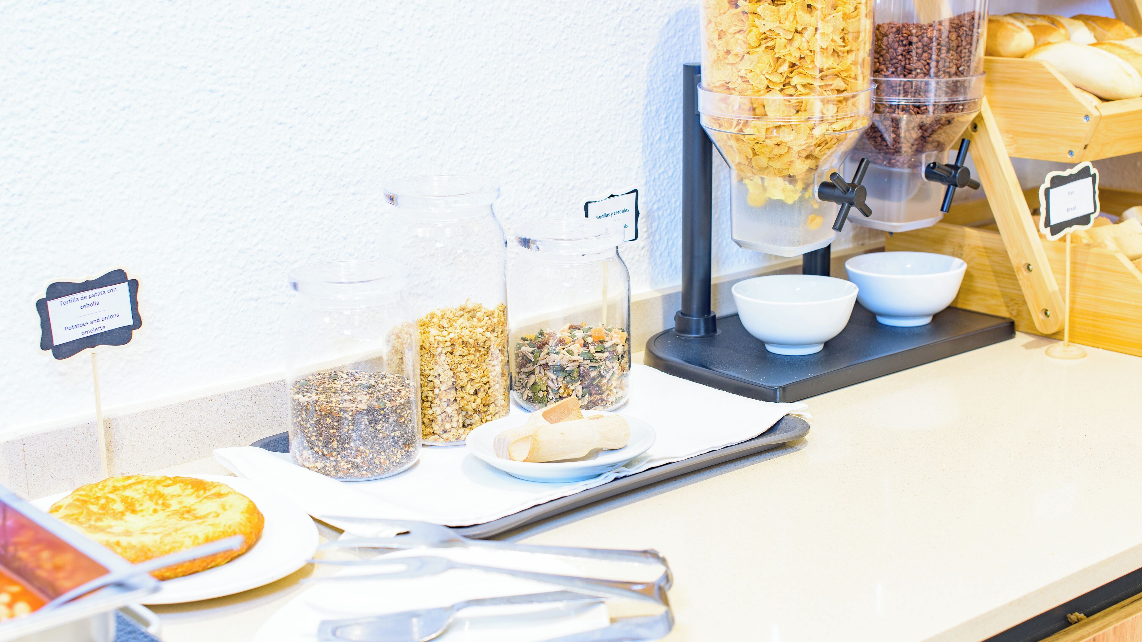 A breakfast buffet with various food items and containers.