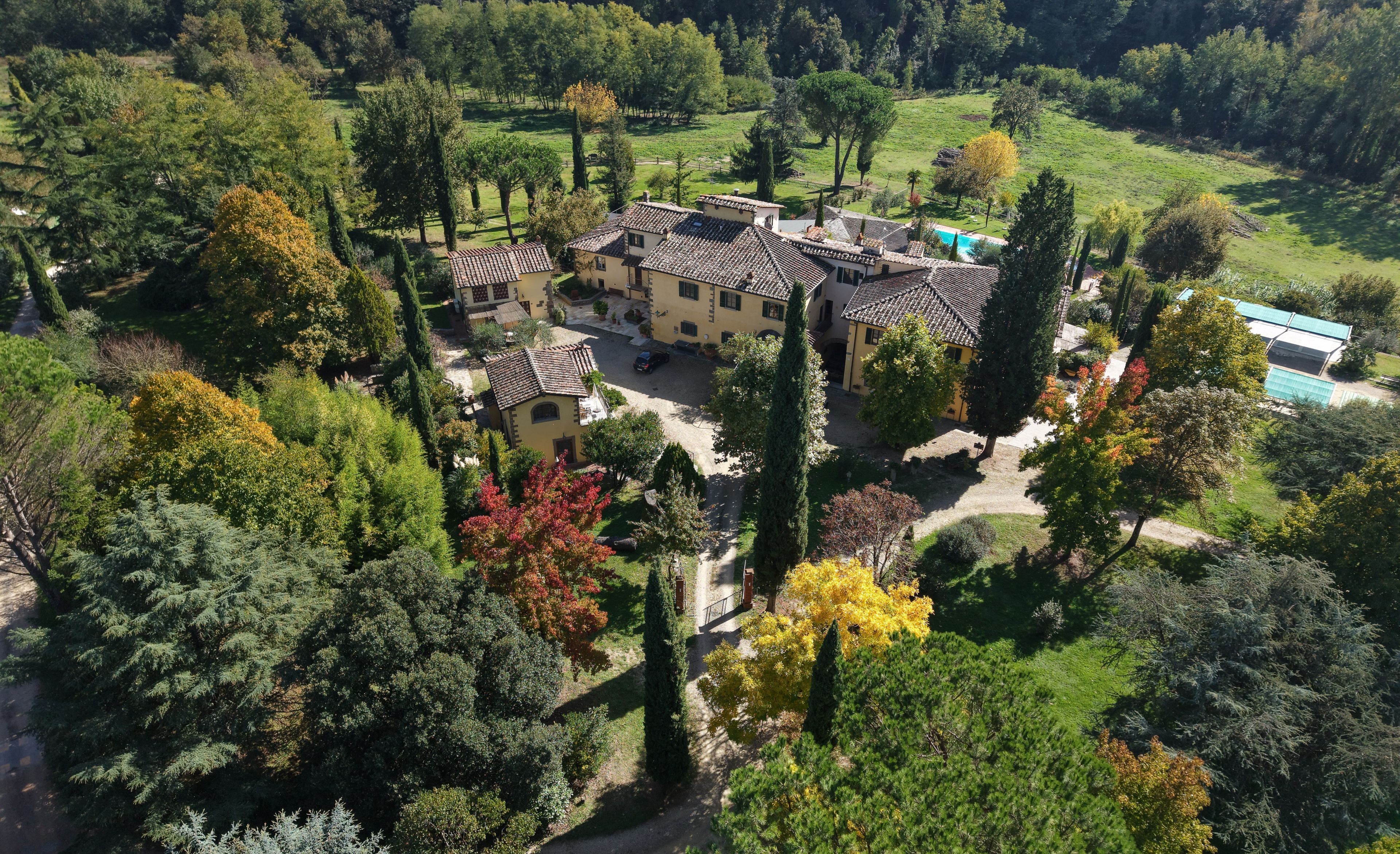 A large estate with multiple buildings, a swimming pool, and a well-maintained garden.