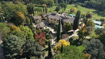 A large estate with multiple buildings, a swimming pool, and a well-maintained garden.