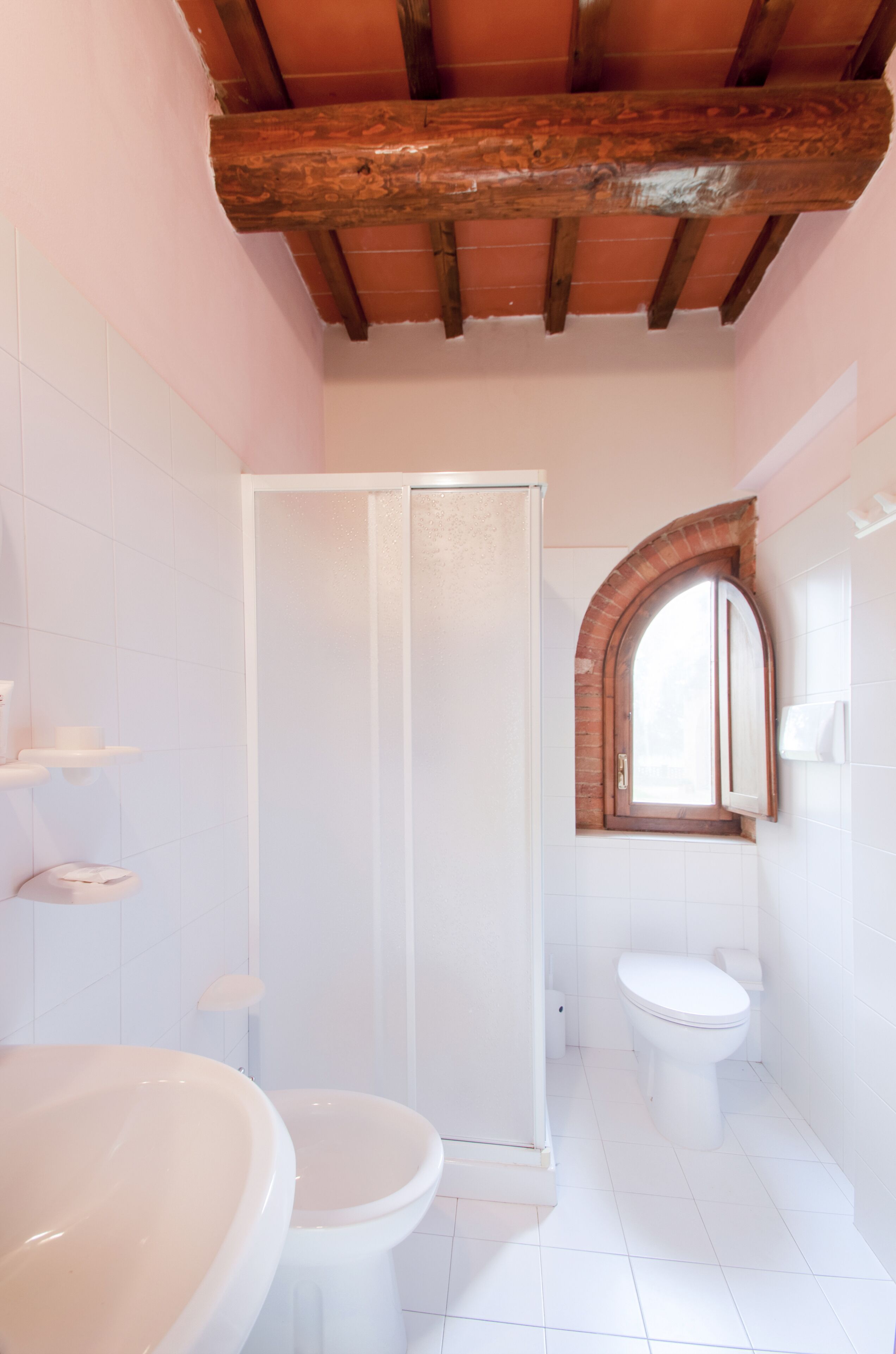 A bathroom with a shower, toilet, and sink.