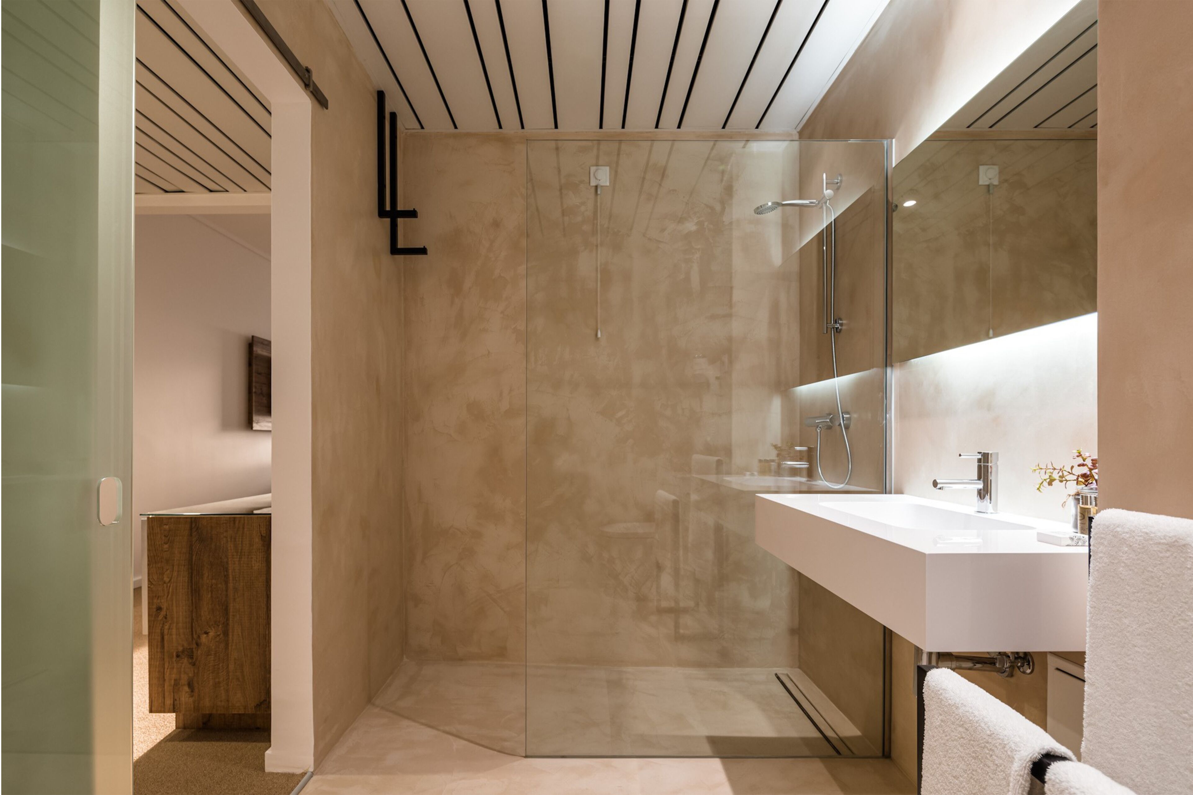 shower, hair dryer, slippers, towels