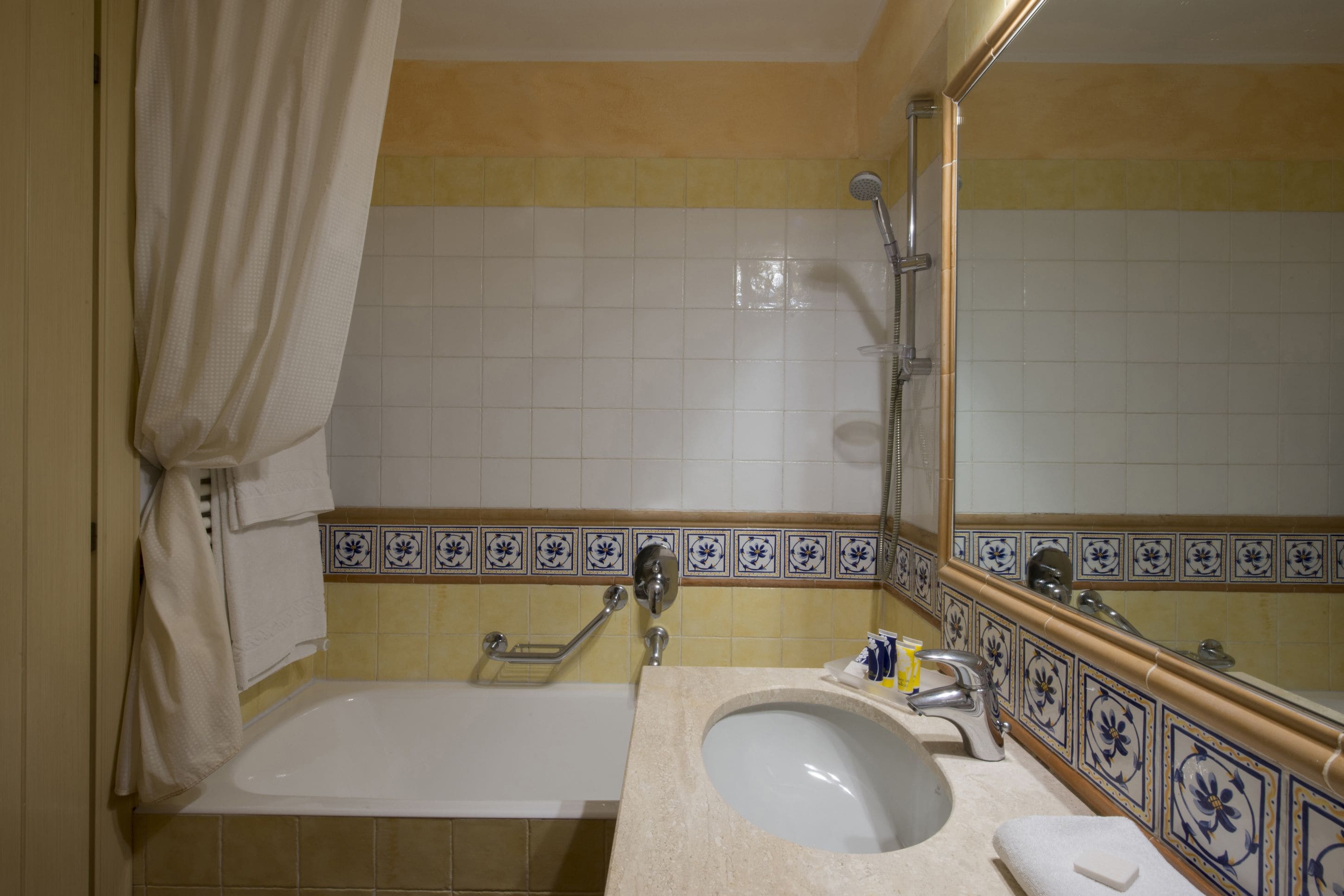 A bathroom with a bathtub, a sink, and a shower.