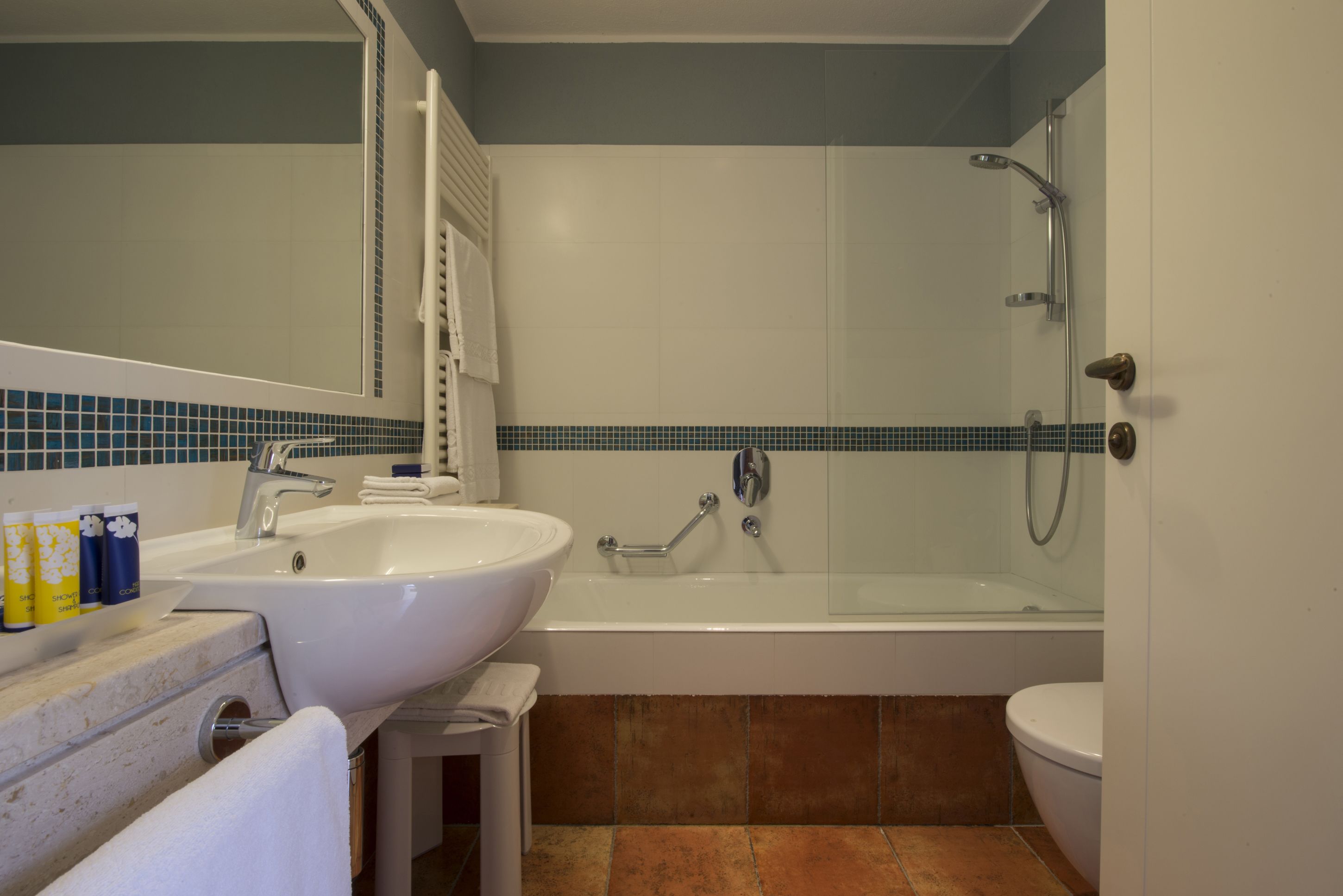 A bathroom with a sink, bathtub, and toilet.