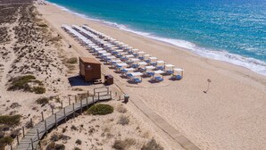 An aerial view of a beach with rows of sunbeds and a wooden building labeled "Ria Park Hotels". - Vale Do Garrão Villas (Loulé)
