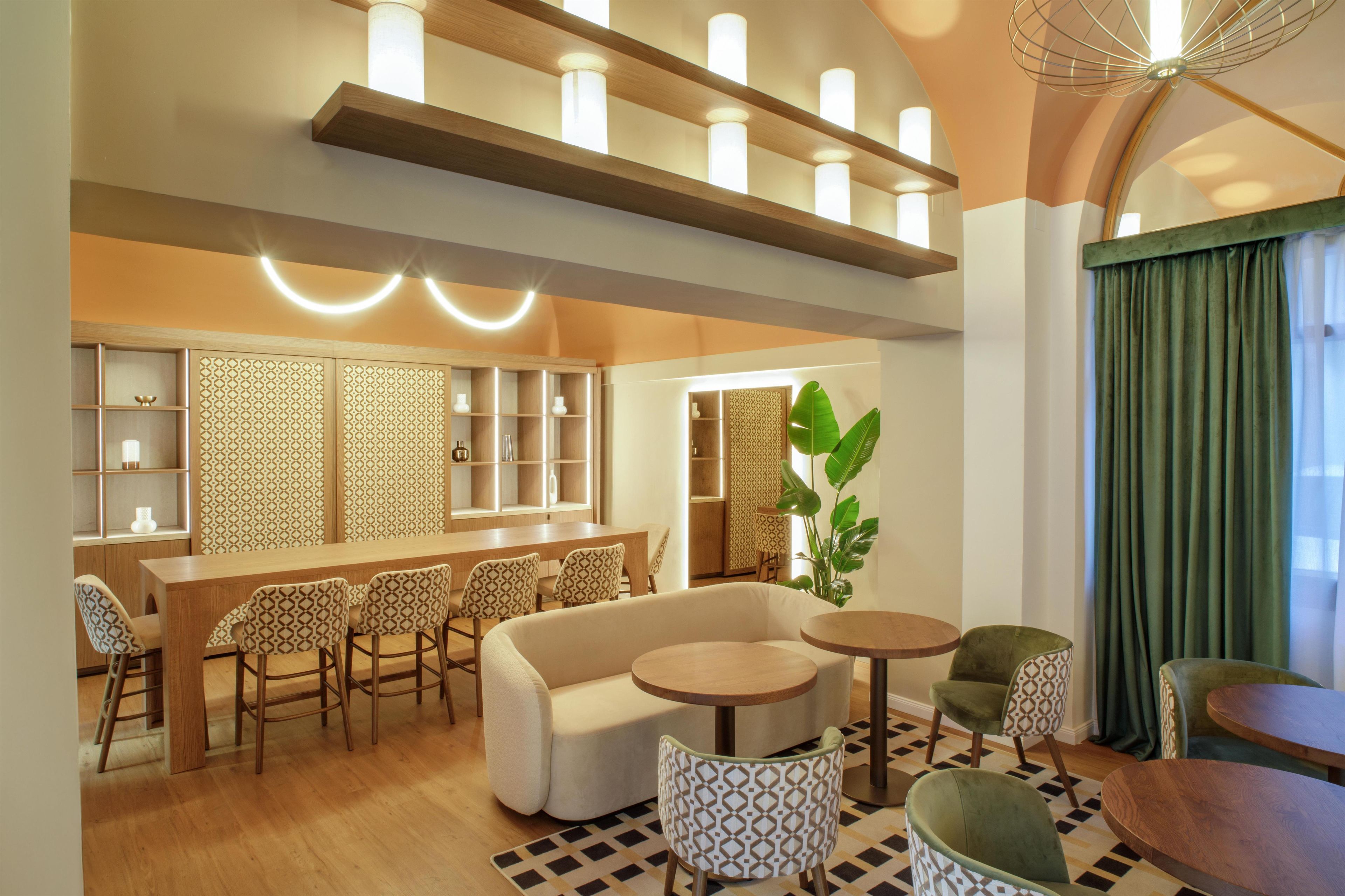 Un espace de détente moderne comprenant un canapé, une table à manger, des chaises et une petite table basse.