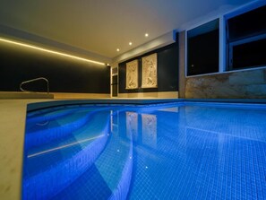 Outdoor pool, a waterfall pool, pool loungers