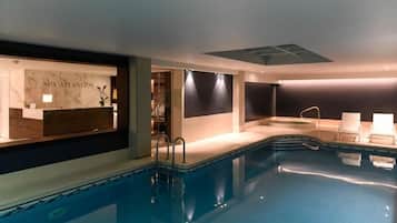Relax by the rectangular pool surrounded by a low edge, with steps on either side.