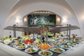 A buffet setup with various food items and a backdrop of a waterfall. - Dessole Le Hammamet Resort (Hammamet)