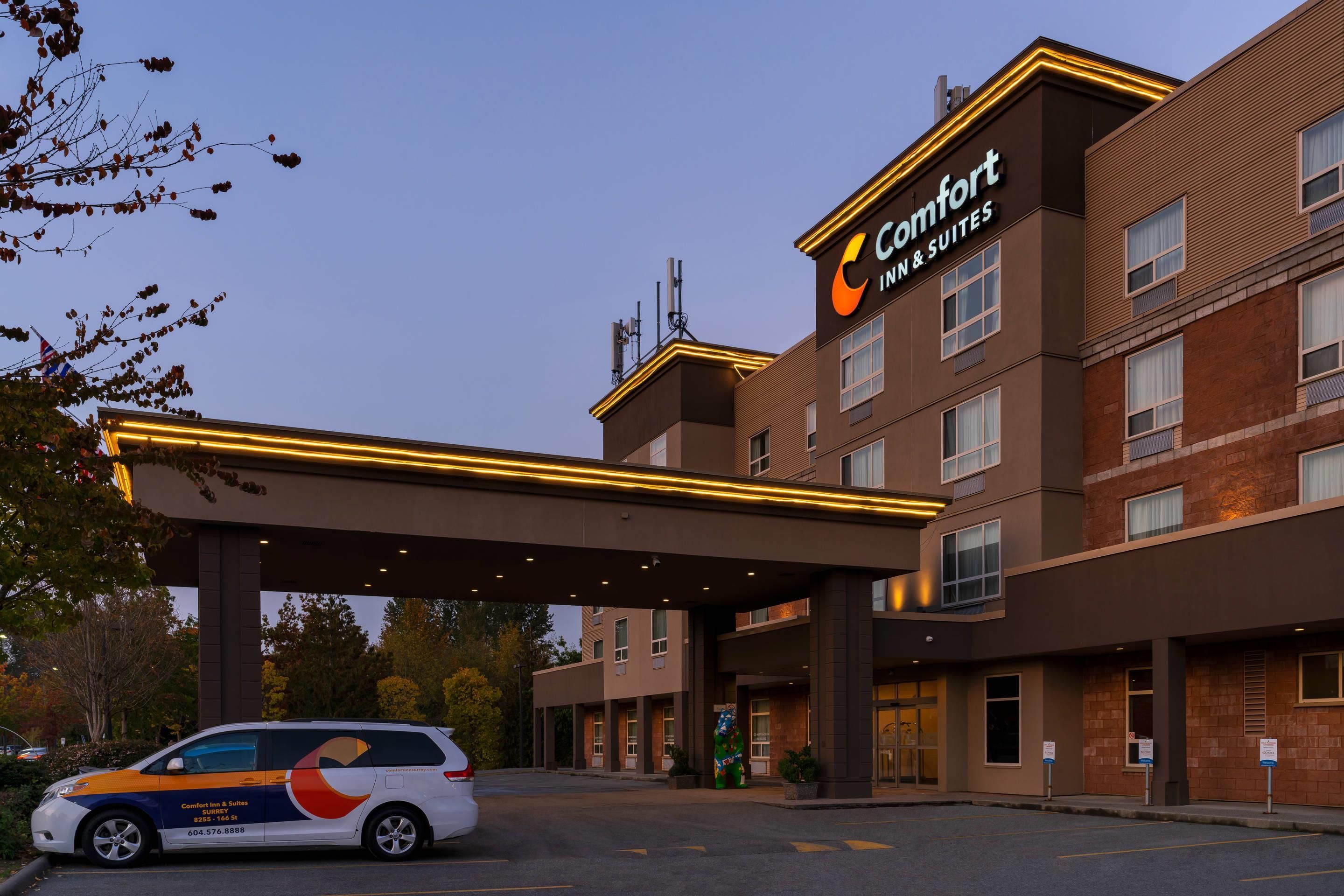 A Comfort Inn & Suites hotel with a covered entrance and a parking area.