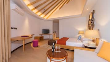 A modern hotel room with a loft bed, a desk, a television, and a dining area.