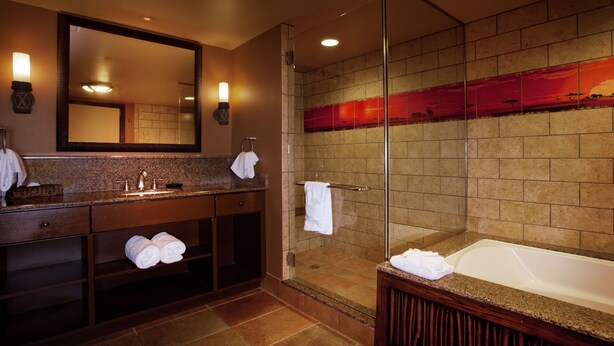 A modern bathroom with a glass-enclosed shower, a large mirror, and a bathtub. - Disney's Animal Kingdom Villas - Kidani Village (Kissimmee)