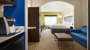 A hotel room with a bed, a sofa, a coffee machine, and a desk. - Holiday Inn Express & Suites San Antonio NW - Medical Area by IHG (San Antonio)