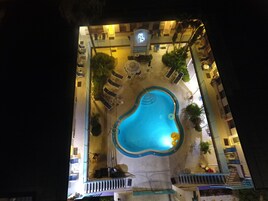 Outdoor pool, a heated pool, open 9:00 AM to 9:00 PM, pool umbrellas