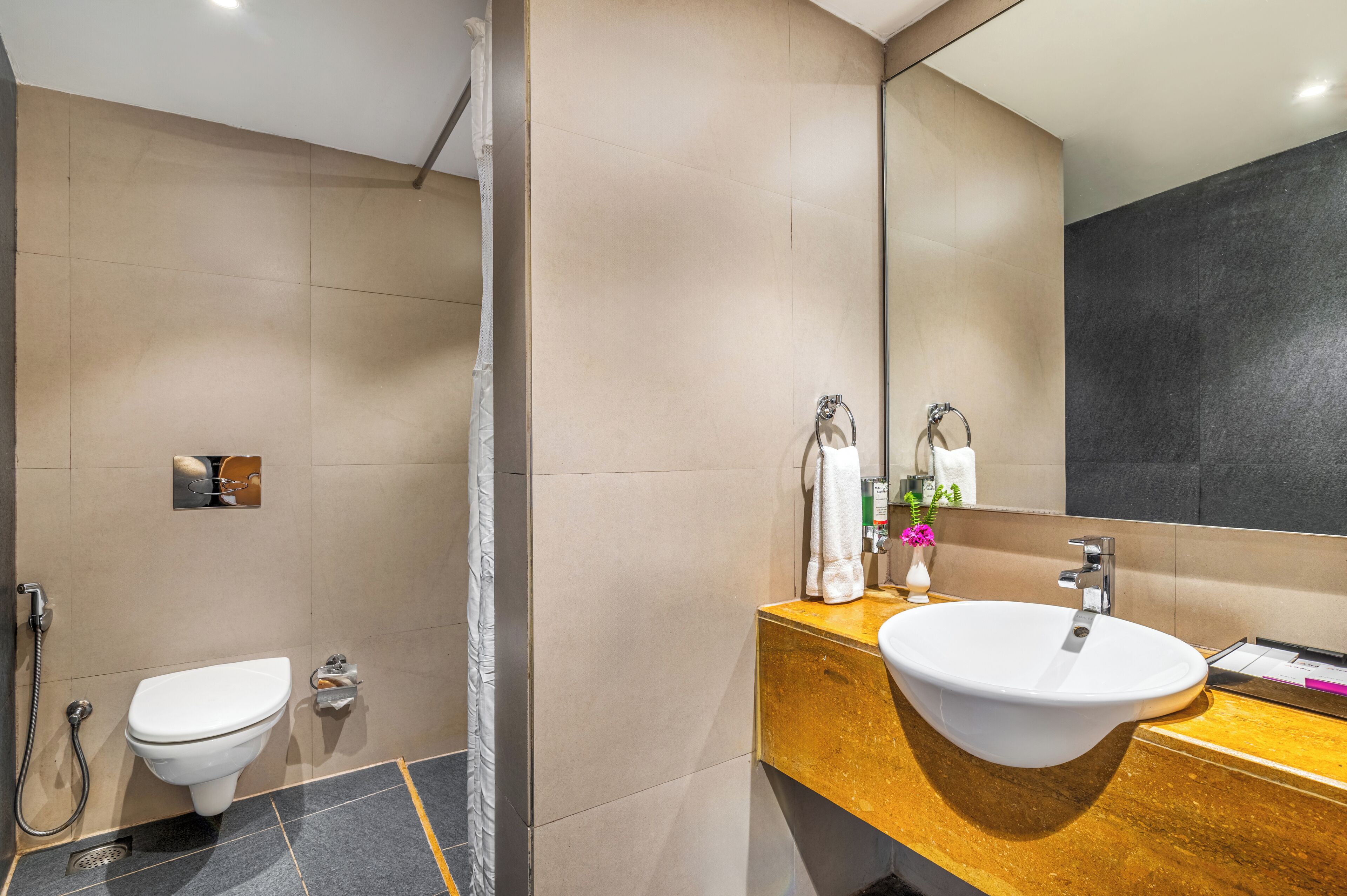 A modern bathroom with a toilet, bidet, and sink.