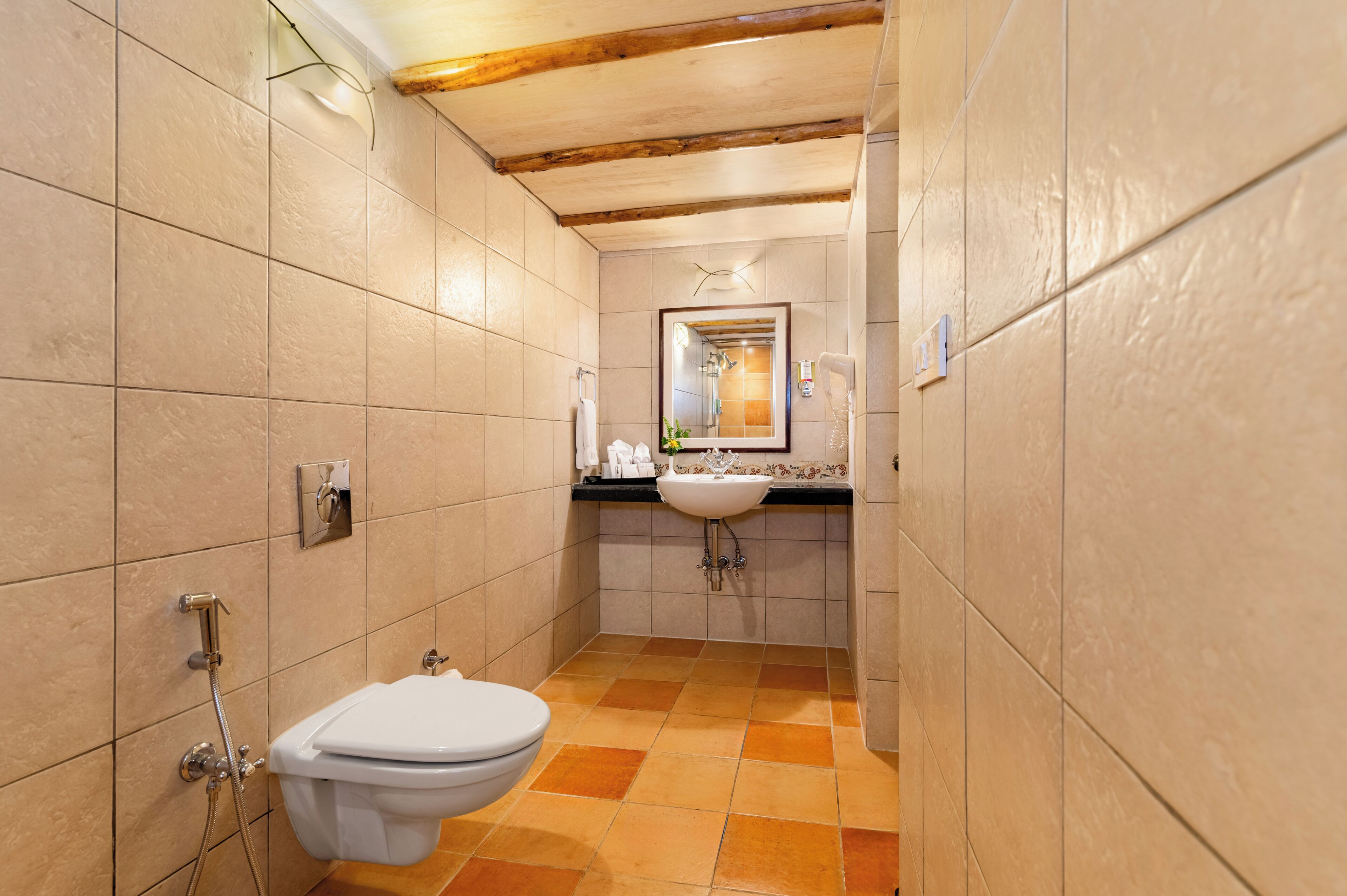 A bathroom with a toilet, sink, and shower.
