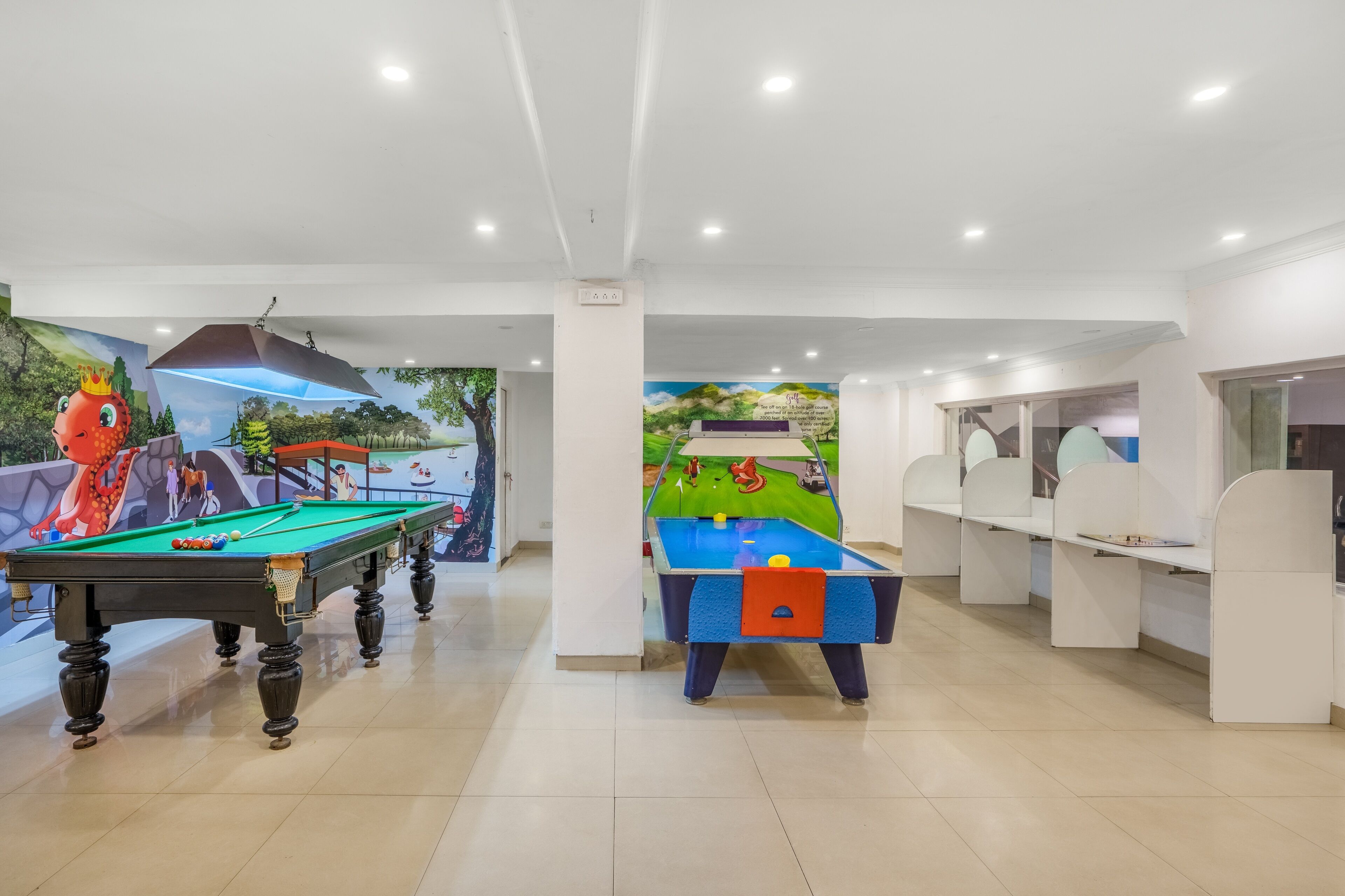 A pool table area with two tables, one with a red octopus decoration and another with a blue tablecloth.