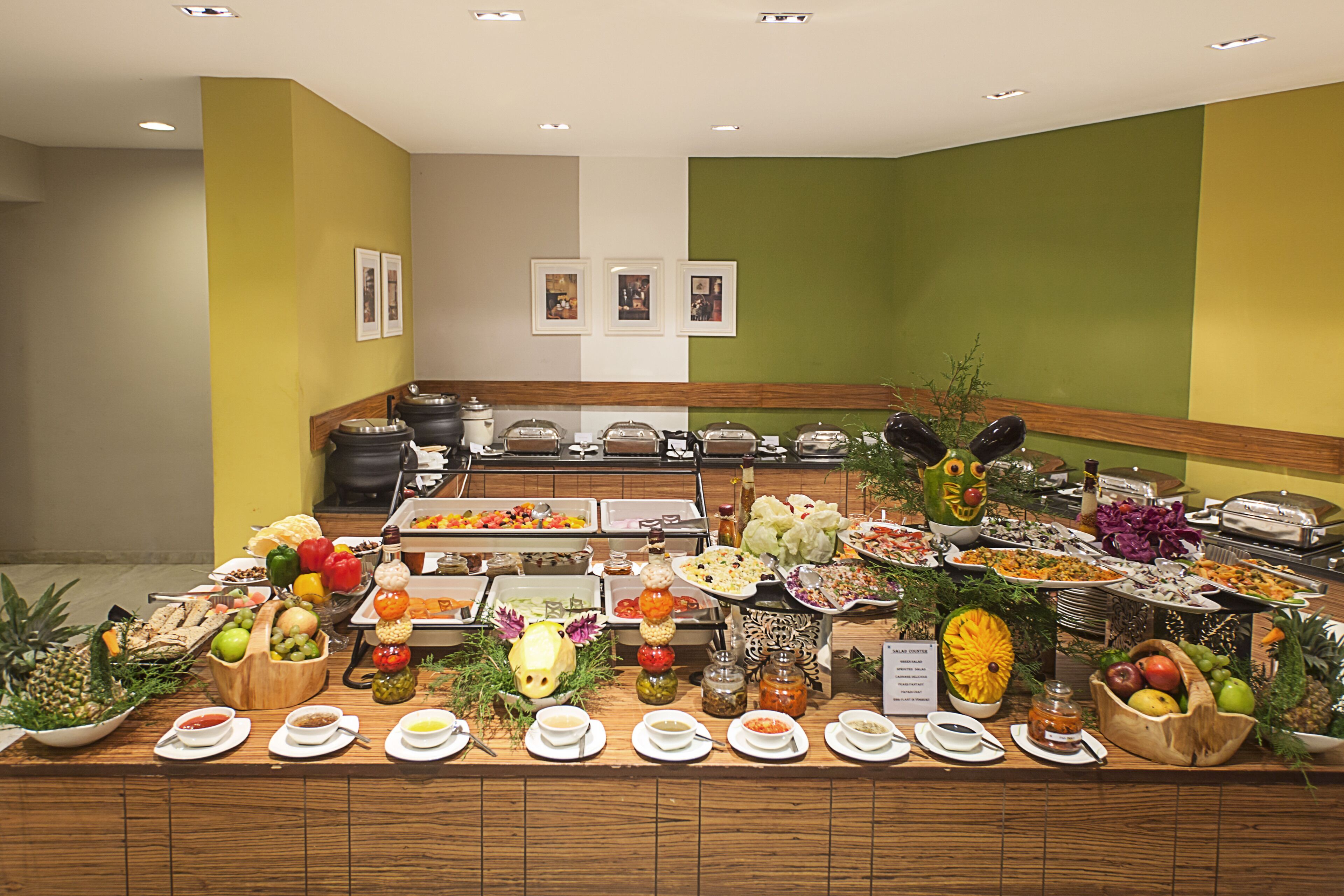 A buffet with various food items and condiments.