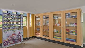 A library with wooden cabinets containing books and magazines.