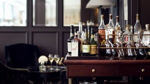 A bar area with a variety of liquor bottles and glasses. - Hotel Haven (Helsinki)