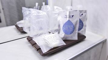A tray with several toiletry bags on a white counter.