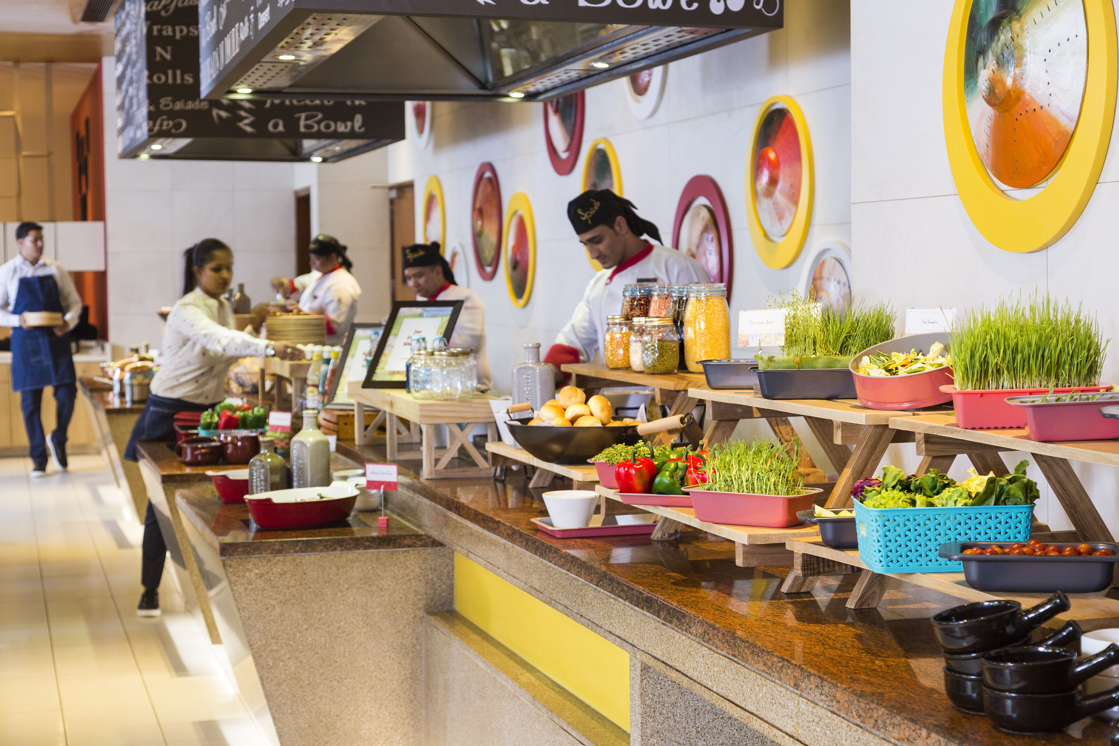 A buffet area with various food items and condiments.