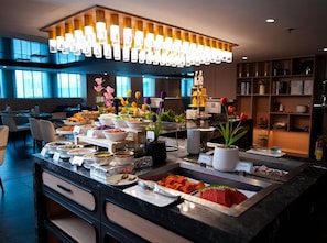 A buffet setup with various food items and a modern interior design.
