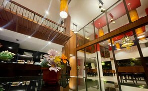 A modern interior with a staircase, seating area, and decorative lighting. - Siam Piman Hotel (Bangkok)