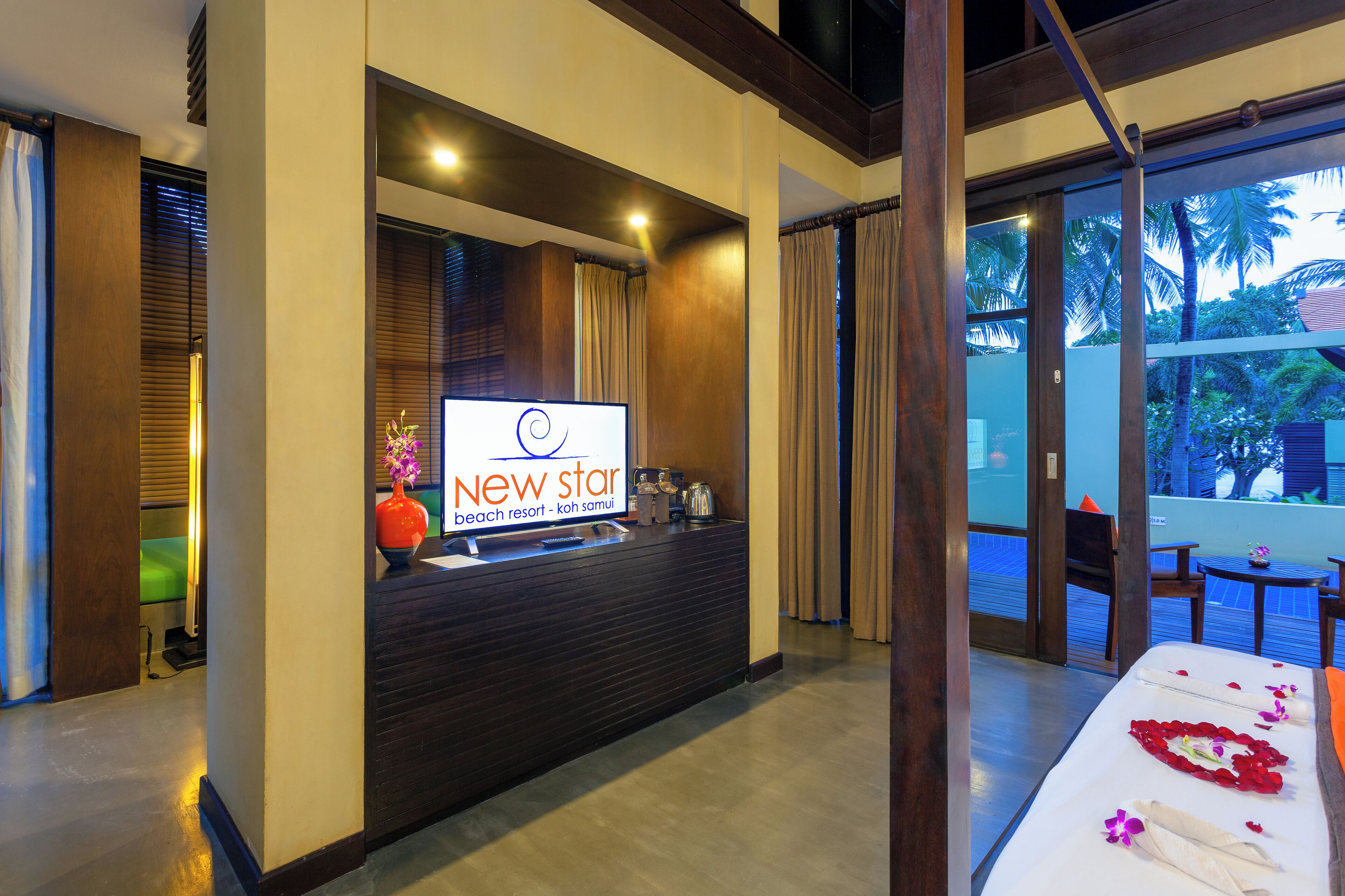 A reception desk with a sign reading "New Star beach resort - koh samui".