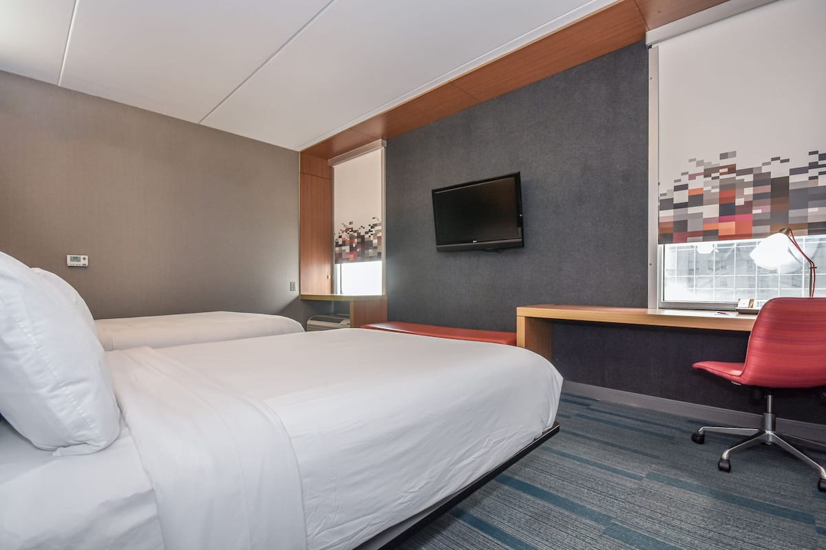 Hypo-allergenic bedding, desk, laptop workspace, blackout drapes
