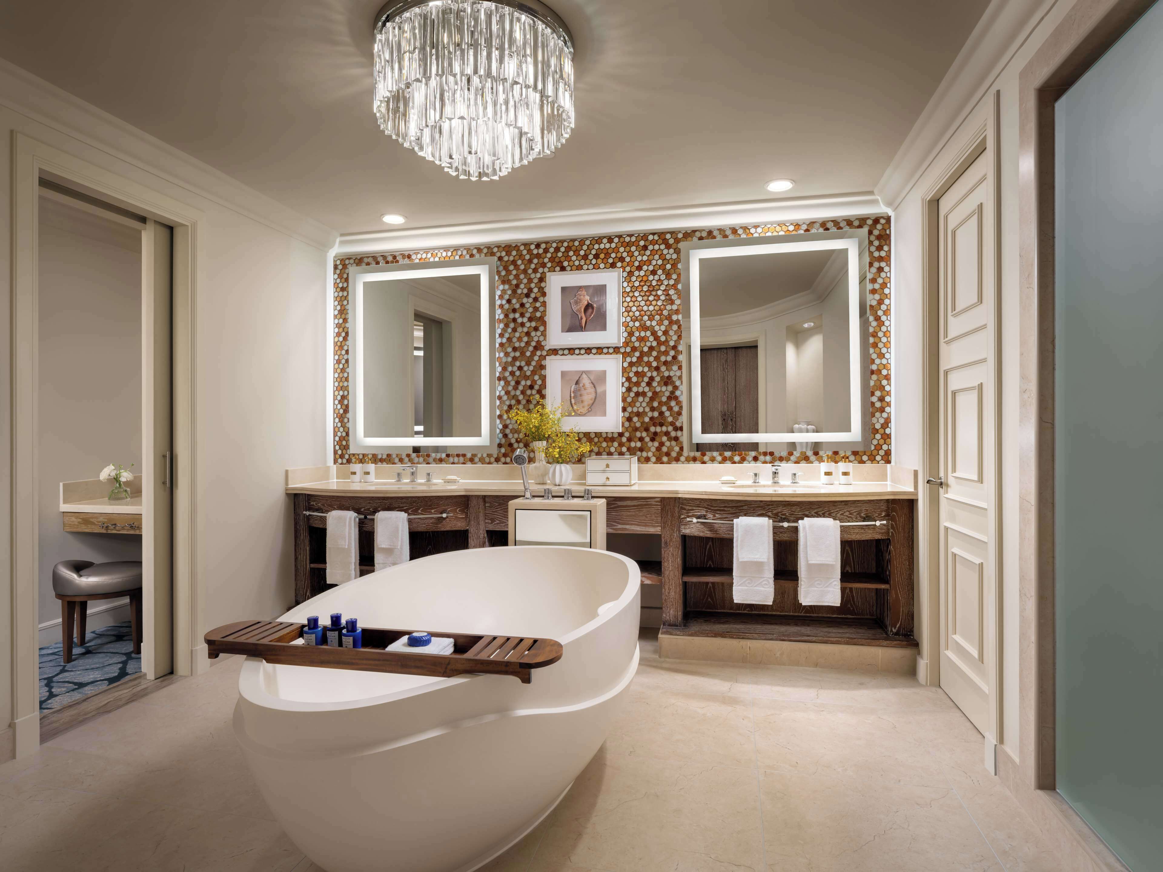 A modern bathroom with a freestanding bathtub, double sinks, and a large mirror above the vanity.