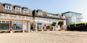 A hotel with multiple floors, a balcony, and a gravel courtyard. - Beachcroft Hotel, BW Signature Collection (Bognor Regis)