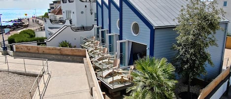 A building with a unique architectural design, featuring a curved roof and a flagpole.
