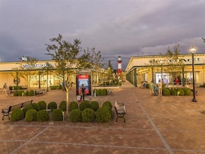 A shopping area with a Michael Kors store, a Coach store, and a kiosk. - Baymont by Wyndham Savannah I-95 (Savannah)