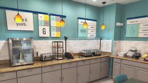 A kitchen with a coffee maker, toaster, and food storage containers. - Grander Inn & Suites by IHG (Tyler)