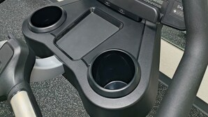 A stationary bike with a digital display, control buttons, and a cup holder. - Grander Inn & Suites by IHG (Tyler)