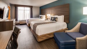 A hotel room with two beds, a desk, a chair, a bench, and a large window with curtains. - Best Western Plus Champaign/Urbana Inn (Champaign)