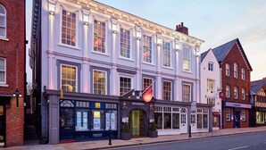 A multi-story building with a classic architectural style, featuring large windows and a prominent entrance with a sign. - Oddfellows Chester Hotel and Apartments (Chester)