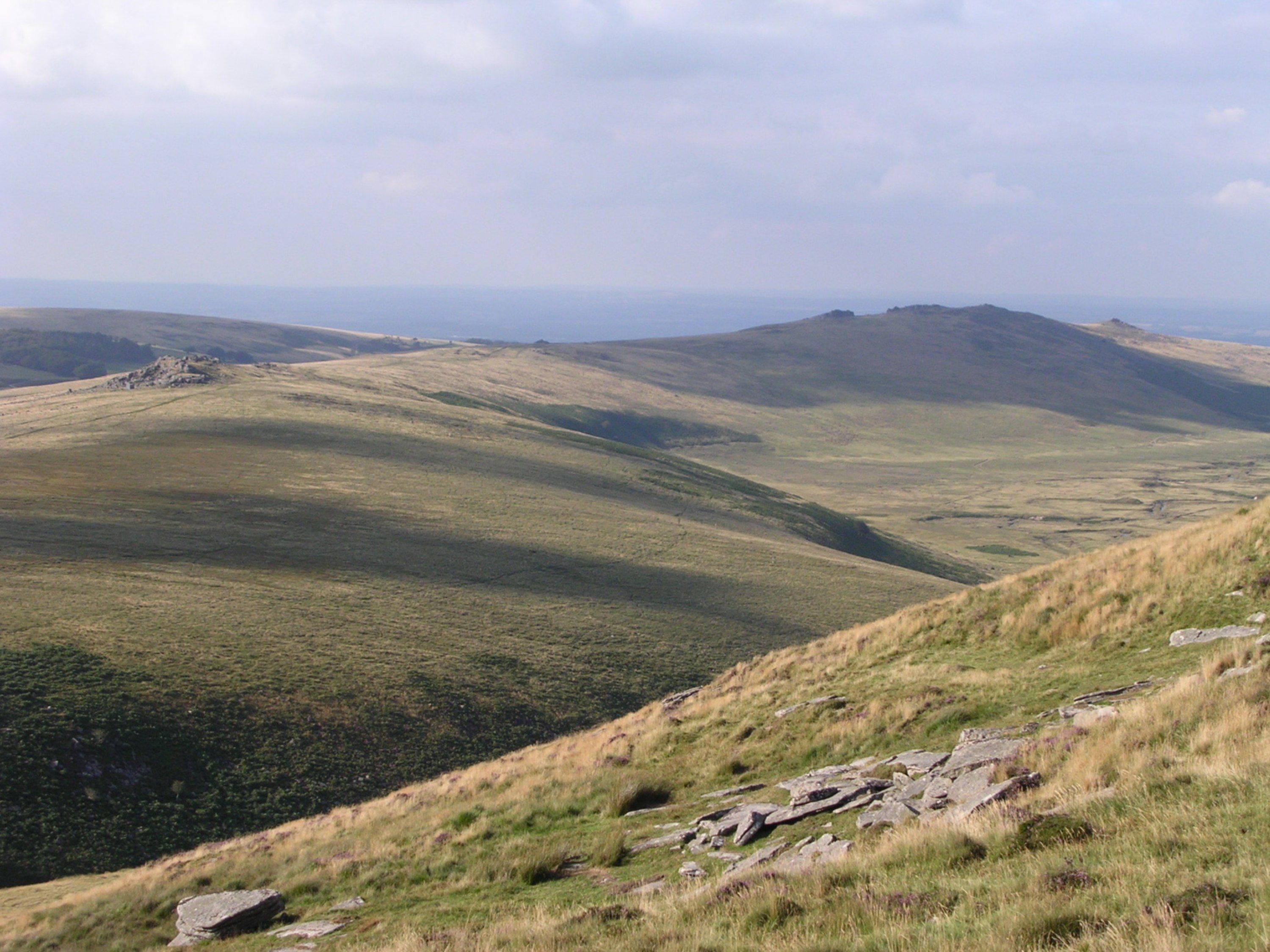 A panoramic view of rolling hills with a clear sky.