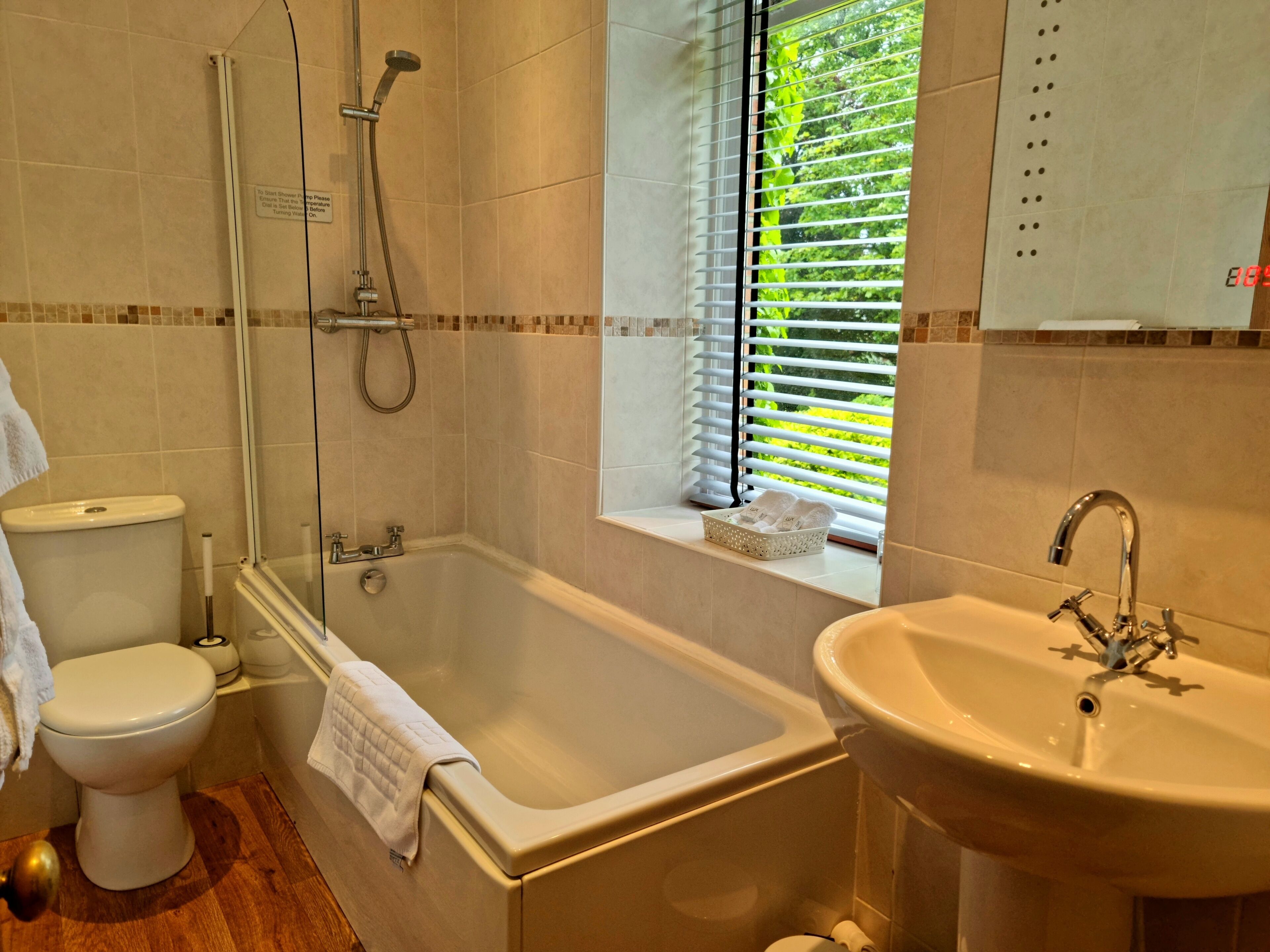 A bathroom with a bathtub, toilet, and sink.
